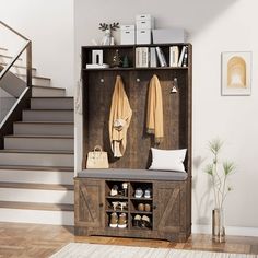 an entryway with a bench, coat rack and stairs