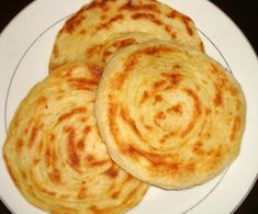 four flat breads on a white plate