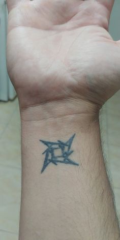 a person's arm with a tattoo on it that has the letter d in two letters