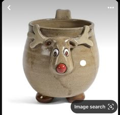 a ceramic cup with a nose and antlers on it's head is shown