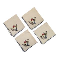 four embroidered napkins with cats and flowers on them