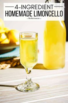 a glass filled with lemonade sitting on top of a wooden table