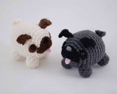 two small crocheted dogs sitting next to each other