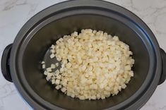 diced onions in a pot with a spoon on the counter top, ready to be cooked