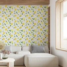 a white couch sitting in front of a yellow and green wallpapered living room