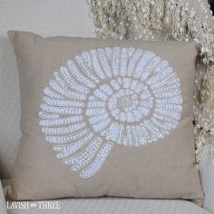 a decorative pillow on a white couch