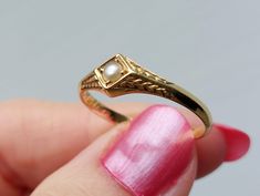 Sweet dainty ring with ornate shoulder and a pearl at the center. The ring is engraved inside "v. Vater u. Mutter", which means "from Father and Mother" in German. There are also the initials "A. W." engraved inside the band. This ring is a lovely antique sentimental piece. Details: The ring is stamped "18k" inside standing for 18ct gold. Condition:  Condition is excellent, solid shank, securely set pearl. Measurements: The ring is a US size 8 1/2. Weight: 2.5g. Please note that I don't accept r Classic Pearl Ring With Birthstone For Wedding, Classic Pearl Wedding Ring With Birthstone, Classic Wedding Pearl Ring With Birthstone, Yellow Gold Pearl Ring With Birthstone For Wedding, Antique Gold Pearl Ring For Wedding, Gold Pearl Ring With Single Diamond For Promise, Gold Pearl Ring With Single Diamond For Wedding, Victorian Yellow Gold Pearl Ring For Wedding, Victorian Style Yellow Gold Pearl Ring For Wedding