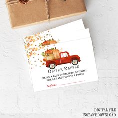 a red truck with pumpkins on it is next to a brown box that says diaper raffle