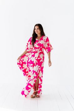 Features V neck Short, flowy sleeves Smocked waist Upper back tie with deep V back Side slits on skirt Fuchsia color with light pink floral print 100% Polyester Size + Fit Small 0-4, Medium 4-8, Large 8-12 Kristin is 5'4", a size 1 and is wearing a Small Runs true to size. Measurements taken while laying flat and then doubled. They do no account for stretch. Click here for shorts Size Bra Band Length Small 34" 58" Medium 36" 59" Large 38" 59" Pink Floral Print V-neck Maxi Dress, Pink V-neck Dress With Elastic Waistband, Pink Summer Dress With Smocked Back, Pink Floral V-neck Dress For Brunch, Pink V-neck Rayon Dress, Chic Pink Dress With Elastic Waistband, Summer V-neck Floral Dress With Smocked Back, Summer Floral V-neck Dress With Smocked Back, Flowy Floral Dress With Flutter Sleeves For Beach