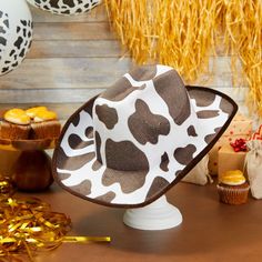 Instantly elevate your costume for a costume party, Halloween party, rodeo, festival, or performance with this fun cowboy hat. The white and brown cow print cowboy hat is ideal for showing off your style while line dancing, bull riding, or simply running errands. The comfortable and breathable EVA velvet will be sure to block out the sun and keep your head cool. The western hat measures 14.2 x 11.5 x 5 inches and has an elastic string to comfortably fit on most youth head sizes. Western White Costume Hats And Headpieces For Summer, White Western Costume Hats And Headpieces For Summer, Western Style Halloween Costume Hats And Headpieces, Western Costume Hats And Headpieces For Rodeo Halloween, White Wide Brim Costume Hat For Festival, Western Hats For Halloween And Western-themed Events, Western Style Hats For Halloween And Western-themed Events, White Brimmed Costume Hat For Rodeo, White Wide Brim Festival Hat