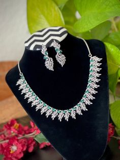 Extremely Gorgeous and Pretty White gold Plated CZ necklace with matching earrings and tikka is an elegant set for your local gatherings or parties! Measurements of the earrings: -------------------------------- Height of the earrings: 4.5 cm Width: 1.3 cm Care Instruction : Avoid Heat & Chemicals Like Perfume, Deo, Alchol, Etc. | Clean With Dry Cotton Cloth | Pack In our Anti tarnish box after use. Hand Set American Diamond Necklace For Party, Festive American Diamond Jewelry Sets For Party, Festive Party Jewelry With American Diamonds, Festive American Diamond Jewelry For Party, Festive American Diamond Party Jewelry, Hand-set American Diamond Kundan Necklace For Party, Party Kundan Necklace With American Diamond, Hand Set American Diamond Kundan Necklace For Party, Silver Kundan Necklace With American Diamonds For Party