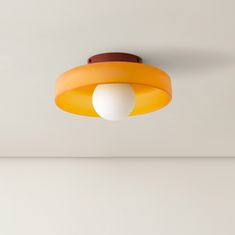 an orange and white light hanging from the ceiling