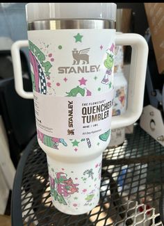 a starbucks cup sitting on top of a metal table