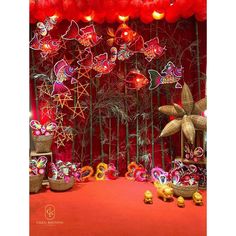 a red stage decorated with paper lanterns and decorations