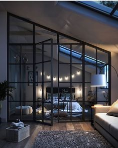 a bedroom with glass walls and lots of lights