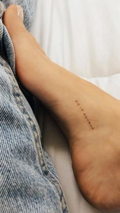 a woman's foot with the word love written on her left side and an inscription below it