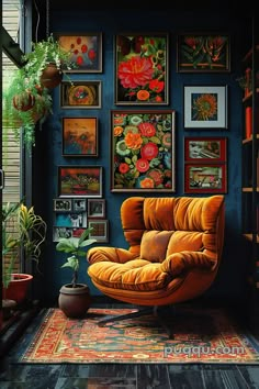 an orange chair sitting in front of a bunch of framed pictures on the wall next to a potted plant