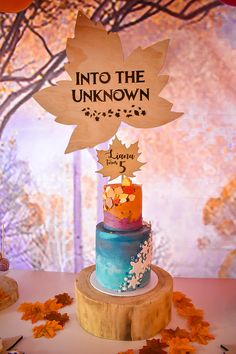 there is a cake that has been decorated with leaves on it and the sign says into the unknown