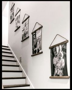 a staircase with pictures hanging on the wall