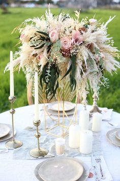 the table is set with flowers and candles