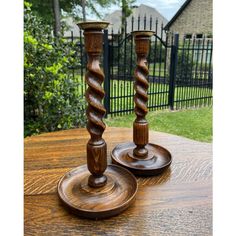 two wooden candlesticks sitting on top of a table