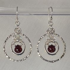 Hill tribe sterling and faceted garnet drop earrings on Bali earwires. 1.25" long from the wire. 7 grams total weight. Gift boxed. One of a kind, handmade in the USA by Aislyn of Urban Maille. Sterling Wire Gemstone Bead Drop Earrings, Red Wire Wrapped Drop Earrings, Garnet Drop Earrings With Ear Wire, Handmade Elegant Garnet Earrings, Red Briolette Earrings With Ear Wire, Silver Garnet Dangle Earrings, Nickel-free Garnet Drop Earrings, Faceted Garnet Drop Earrings, Garnet Faceted Drop Earrings