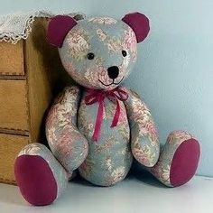 a teddy bear sitting next to a dresser