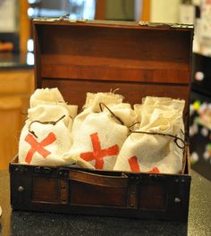 an open suitcase with three bags in it sitting on a table next to a counter