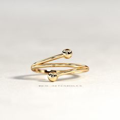 Bypass Gold Ring / 14K Yellow Gold Ball Ring / Bypass Ball Ring / Open Beaded Ring / Gold Open Ring / 14K Gold Spiral Ring ▶ Watch Ring In 360o >> http://bit.ly/BN131 ★ Details : ✔ Shank Width 1.3 mm ✔ Total Width 11.5 mm (bead to bead) ✔ Metal 14K / 18K Solid Gold ✔ Gold Color Yellow / White / Rose ✔ Ring US Size 3-11 / Contact me for other ★ Features : ✔ Handmade & Made to order. ✔ Ready to ship in 6-10 Business days. ✔ Complimentary gift wrapping. ✔ Free insured worldwide shipping. Small Diamond Rings, Bezel Set Diamond Ring, Dainty Diamond Ring, Womens Rings Fashion, Spiral Ring, Womens Ring, Beaded Ring, Bypass Ring, Ringe Gold