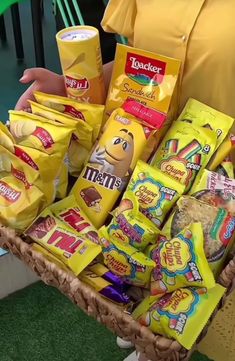 a person holding a basket full of snacks