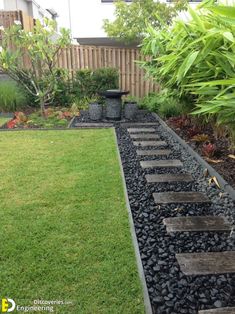 a small garden with stepping stones in the grass