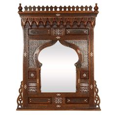 an ornate wooden mirror with carvings on it