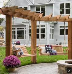 a wooden porch swing sitting next to a fire pit