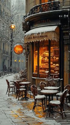 an empty street with tables and chairs covered in snow