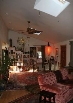 a living room filled with furniture and a ceiling fan in the middle of the room