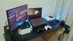 a laptop computer sitting on top of a wooden desk next to a monitor and keyboard