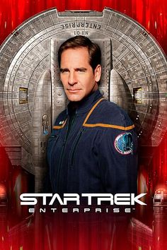 a man standing in front of a red background with the words star trek on it