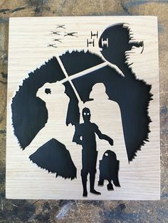 a wooden cutout of a man holding an umbrella with a child in front of him