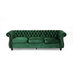 a green velvet couch with buttons on the back and arms, in front of a white background