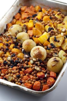 a casserole dish filled with lentils, potatoes and carrots