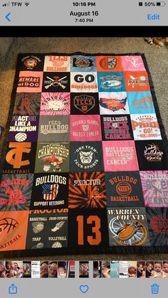 a blanket made out of t - shirts and other items is displayed on the floor