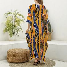 Bask in the glow of the Savannah Sunrise with our African Print Kaftan Robe, a celebration of tribal aesthetics and modern design. This imitation silk V-neck robe is a masterpiece of vibrant colors and bold patterns that reflect the spirit and artistry of the African continent. Each robe is a canvas of orange, blue, and white motifs, reminiscent of the dynamic energy of a sunrise across the savannah. The lightweight blend of 97% polyester and 3% spandex offers a luxurious feel and flowy grace, p V-neck Printed Kimono For Festivals, Spring Bohemian Kaftan With Abstract Print, Yellow Bohemian V-neck Kimono, V-neck Patterned Kimono For Festival, Printed V-neck Kimono For Festival, Yellow Printed V-neck Kaftan, Festival V-neck Printed Kimono, Free Size V-neck Kimono For Festival, Festival V-neck Kimono Free Size