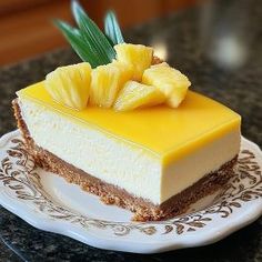 a piece of cheesecake with pineapple on top