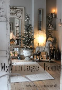 an image of a living room decorated for christmas with horse statue and tree in the corner