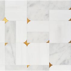 a white and gold tiled wall with geometric shapes