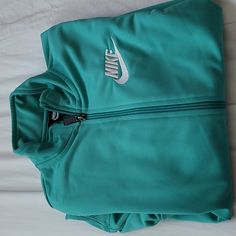 Never Worn. Excellent Condition Nike Green Casual Track Jacket, Nike Casual Green Track Jacket, Casual Green Nike Track Jacket, Nike Green Long Sleeve Windbreaker, Nike Track Jacket With Double-lined Hood, Nike Technical Track Jacket With Moisture-wicking, Nike Nylon Track Jacket With Double-lined Hood, Nike Nylon Windbreaker With Double-lined Hood, Nike Track Jacket