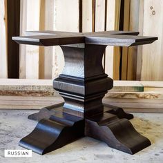 a wooden table sitting on top of a floor next to wood planks and plywood