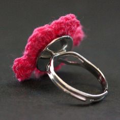 "A deep fuchsia flower crocheted by hand with a soft yellow center has been set on a silver plated ring base with adjustable sizing from size 6 and up in this handmade ring. Flower's size is approximately 1-inch (25mm) in diameter. The adjustable ring base on this crocheted flower ring makes it comfortable to wear no matter the size of the wearer's fingers (size 6 and up) as well as ideal for switching from finger to finger as desired. With a bit of altering to the band, this ring can be made sm Adjustable Pink Crochet Jewelry, Handmade Pink Flower Shaped Rings, Handmade Pink Flower Rings, Handmade Pink Flower-shaped Rings, Fuchsia Flower, Crocheted Flower, Knitted Flowers, Holiday Gift Wrap, Soft Yellow