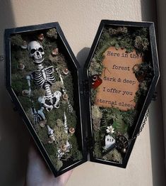 someone is holding an open box with fake skeletons in it and the words here in this forest mark & deep i offer you nothing else