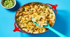 a pot filled with cauliflower and broccoli next to a bowl of celery